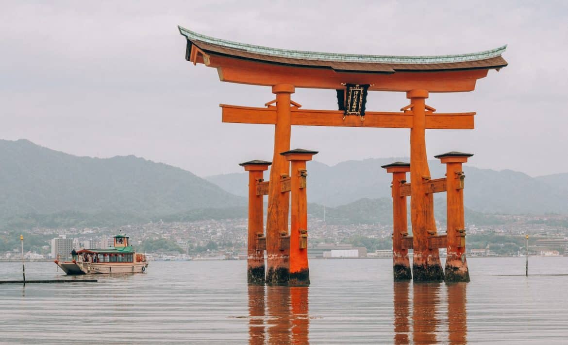 brown wooden arch on body of water during daytime